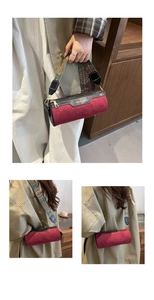 Detail of burgundy frosted cylinder bag featuring ethnic style wide fabric strap