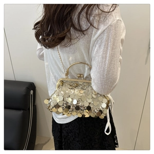 Detail of golden sequins and metallic frame on vintage evening clutch bag