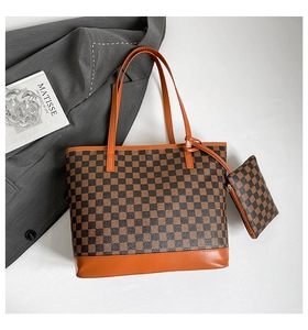 Flat lay of checkered tote bag with matching pouch set on professional business attire