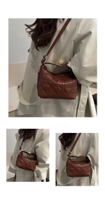 Detailed close-up of brown heart-quilted leather texture and golden hardware accents