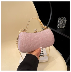 Pink glitter evening clutch bag with gold handle and sparkling diamond clasp detail