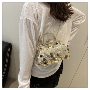 Detail of vintage evening bag with gold and silver sequins and metallic clasp chain