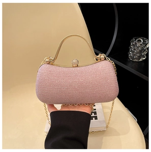 Detail of pink sequin evening clutch bag with gold handle and sparkling diamond clasp