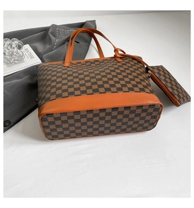 Detail of checkered tote bag set with orange handles and matching zipper pouch