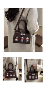 Detail of creative house pattern design on dark brown leather crossbody handbag