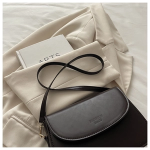 Close-up of the vintage brown leather shoulder bag with debossed FASHION BAGS text