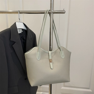 Pale green lychee texture tote bag with golden twist lock for daily commuting