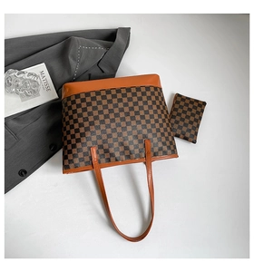 Detailed top view of a brown checkered tote bag set with vibrant orange strap and pouch