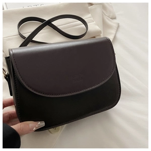Detail of vintage crossbody bag showing the fashion bags logo on matte brown leather