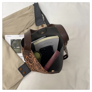 Leopard print bucket bag interior showing large capacity for daily essentials like phones