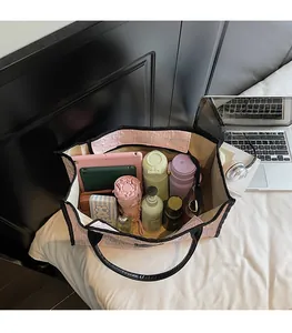 Top view of spacious pink jacquard tote bag interior holding tablet, umbrella and essentials