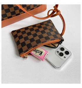 Internal view of checkered tote bag with orange trim showing daily essentials capacity