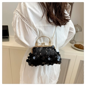 Detail of vintage black sequin evening bag with gold kiss-lock and beaded top handle