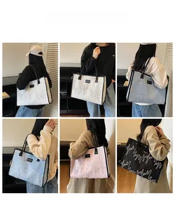 Quilted tote bags shown in four colors with wave embroidery and large capacity