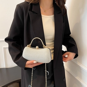 Elegant silver glitter evening clutch with gold metal handle and chain shoulder strap