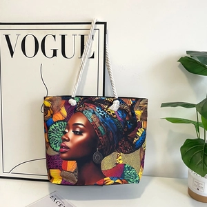 Classic canvas tote bag with African woman print and white rope handles in stylish setting