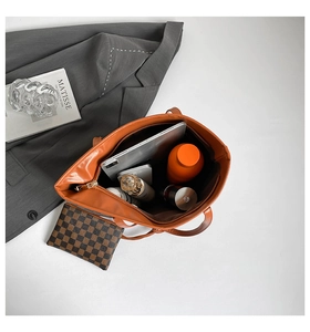 Caramel tote bag showing spacious interior with tablet, flask, and checkerboard pouch