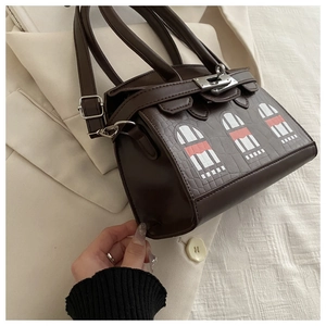 Detail of brown crocodile pattern handbag with colorful window mosaic and silver lock