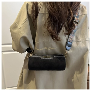 Rear view of black cylinder bag with golden letters and patterned wide strap