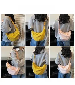 Detail of yellow and pink half-moon crossbody bags with unique woven rope zipper pulls