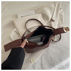 Detail showing internal storage capacity of the brown quilted heart pattern handbag