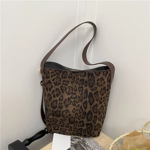 Large leopard print tote bag in retro suede finish with shoulder strap on a table