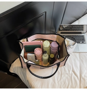 Pink embossed tote bag showing large capacity with laptop, bottle and cosmetics