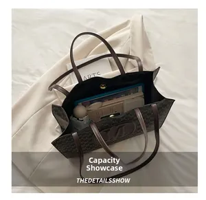 Large capacity brown monogram tote bag showing interior space with tablet and umbrella