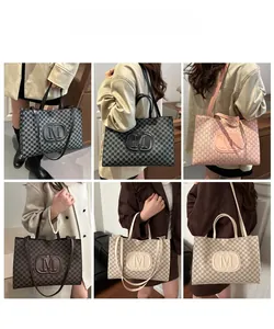 Detail view of large monogram tote bag in black, pink, beige, and brown color options