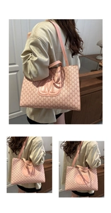 Detail of pink tote bag with M-letter monogram print and textured 3D logo design