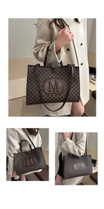 Close-up of vintage M-letter monogram pattern and embossed logo on the tote bag