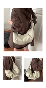 Detail of soft pleated beige hobo bag with adjustable knot handle and ample storage