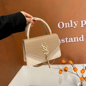 Elegant beige and apricot patchwork crossbody bag with gold S-logo and fringe detail