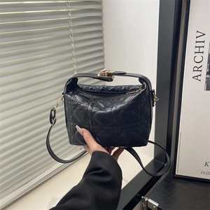 Elegant black heart quilted handbag with gold clasp and adjustable strap for women