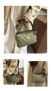 Detail of army green nylon crossbody bag with cute bear embroidery and dual zippers