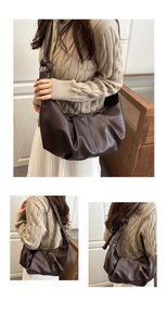 Detail view of large dark brown pleated crossbody bag with premium lychee grain texture