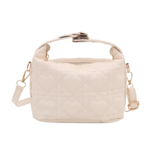 Cream quilted mini bag with heart stitching, top handle and gold latch closure