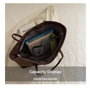 Interior view showing the large capacity of the dark brown tote bag for daily essentials