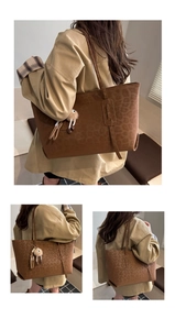 Detail view of brown leopard print tote bag with plush charm and long shoulder straps