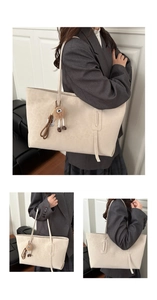 Detail of beige leopard print tote bag with plush charm and long strap decoration