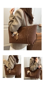 Detail of vintage leopard print tote bag with plush charm and long shoulder straps