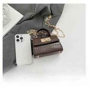 Detail view of dark brown stone pattern bag with gold chain and phone for size reference