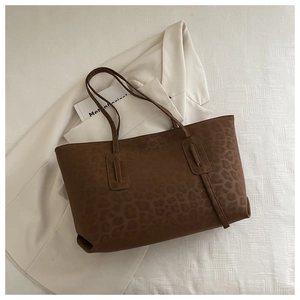 Close-up of leopard print tote bag with soft faux suede texture and reinforced stitching