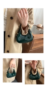 Detail of a green shiny patent leather hobo bag with a zipper and gold hardware