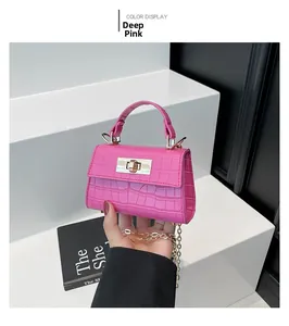 Deep pink crocodile pattern handbag with gold clasp and chain strap detail