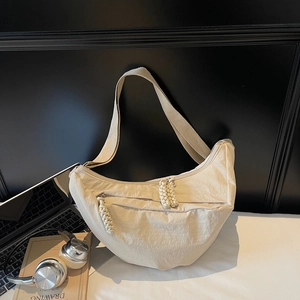 Chic beige nylon half-moon crossbody bag for women with woven zipper pull detail