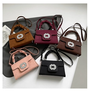 Close-up of stylish handbags with rhinestone buckles and elegant ruched handles
