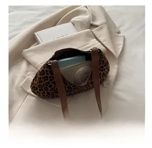 Interior capacity of leopard print shoulder bag with wallet and cosmetics