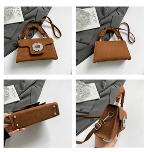 Detail view of brown matte trapezoid handbag with rhinestone buckle and pleated handle