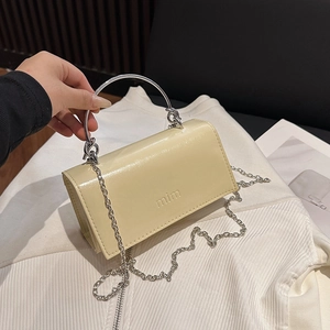 Cream chain crossbody bag with silver ring handle and glossy patent leather finish